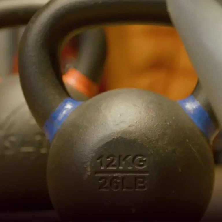 Row of cast iron kettlebells in a home gym
