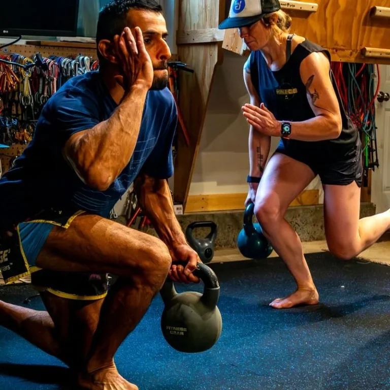 Two athletes training side by side with kettlebells in a garage gym