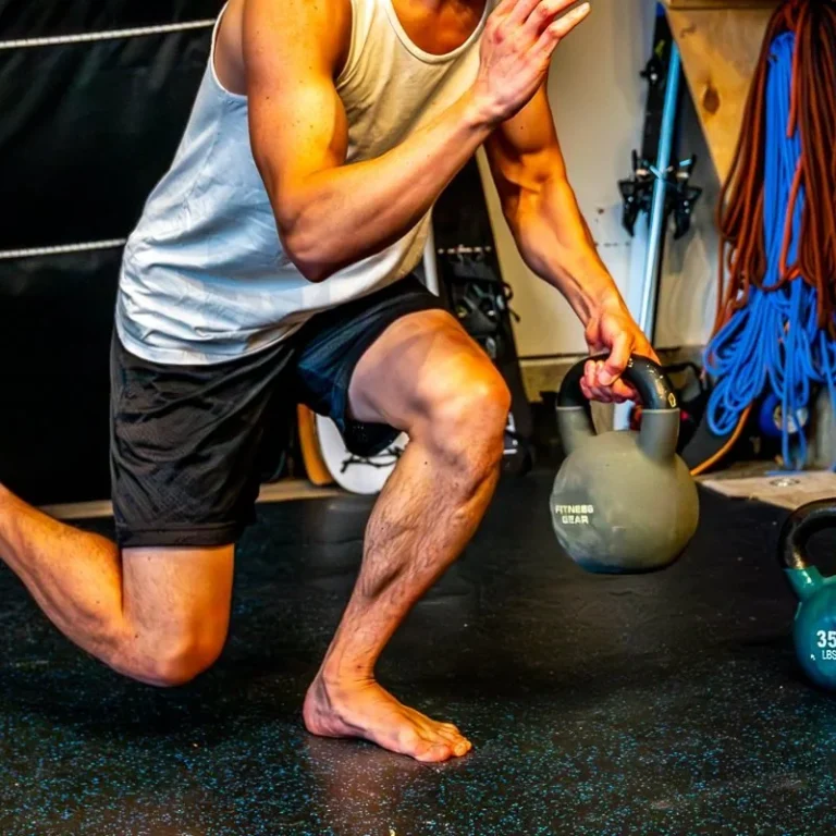 Close view of an athlete's bent knee in a loaded reverse lunge